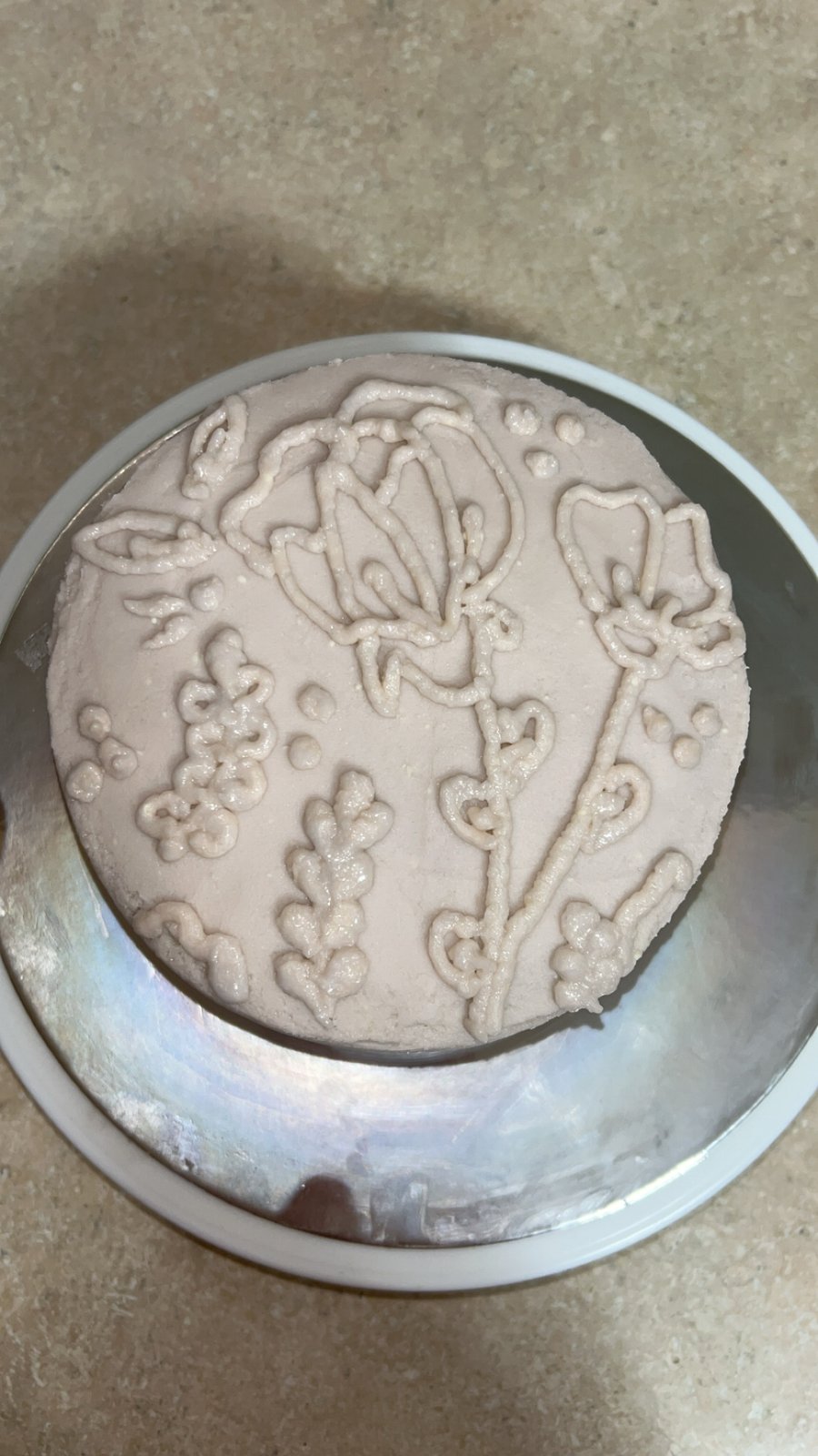 Blush pink cake with floral piped design